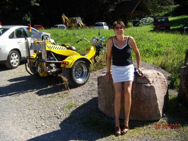 waltraud white mini skirt near a trike